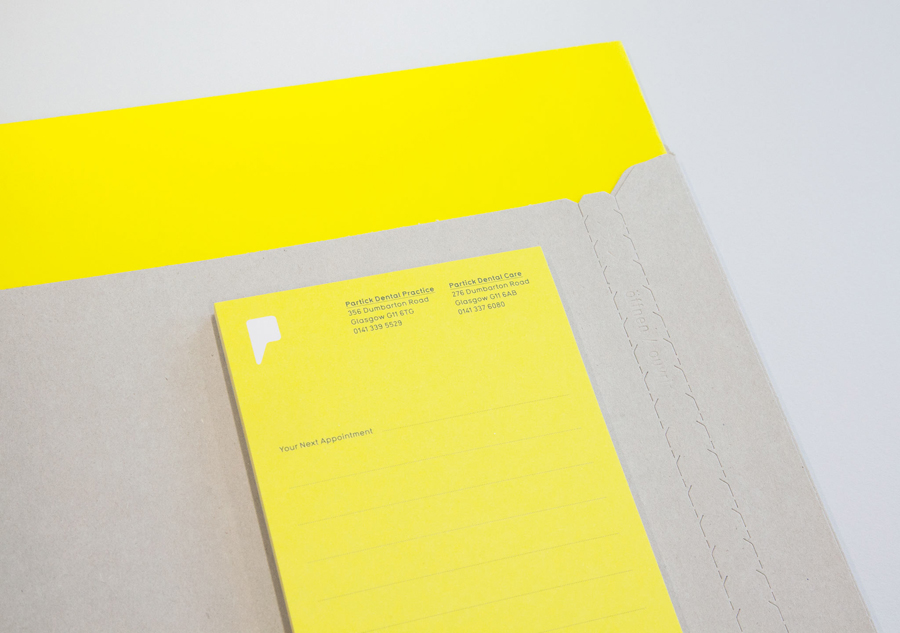 Logo and stationery with yellow and grey paper and board detail designed by Freytag Anderson for Partick Dental featured on BPO