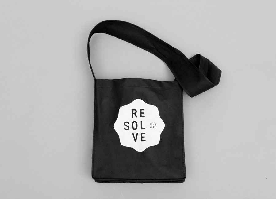 Logo as a white ink print detail across a black bag created by Neue for cleaning and restoration service provider Resolve