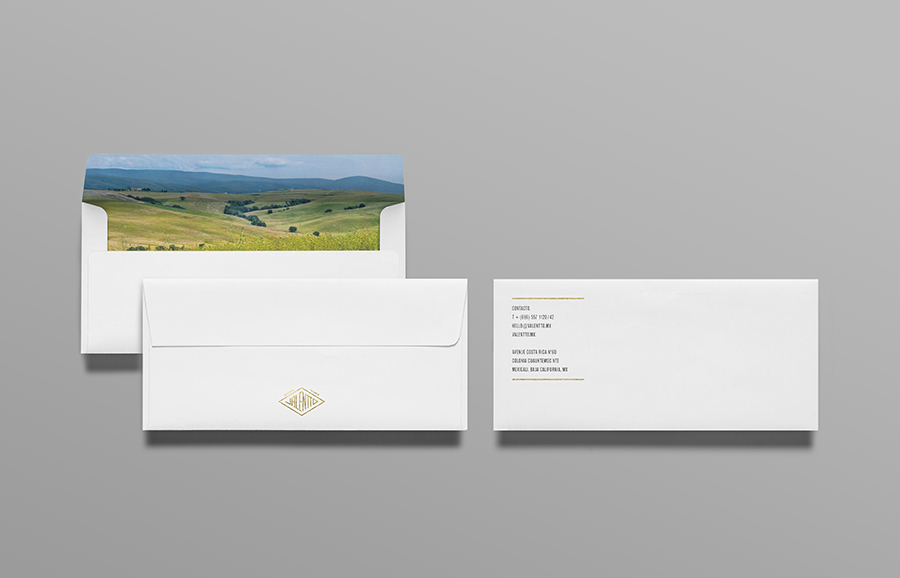 Logo and envelope with gold foil and photographic landscape detail designed by Anagrama for olive oil brand Valentto