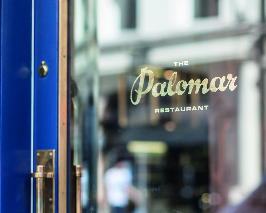 Logotype as gold painted signage designed by Here for Soho restaurant The Palomar