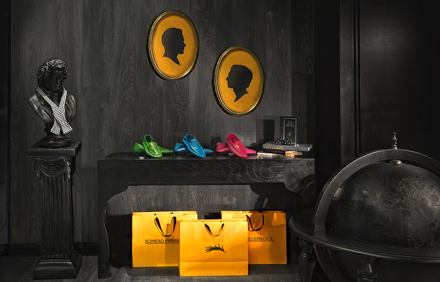 Orange shopping bags created by Anagrama for luxury slipper brand Romero+McPaul