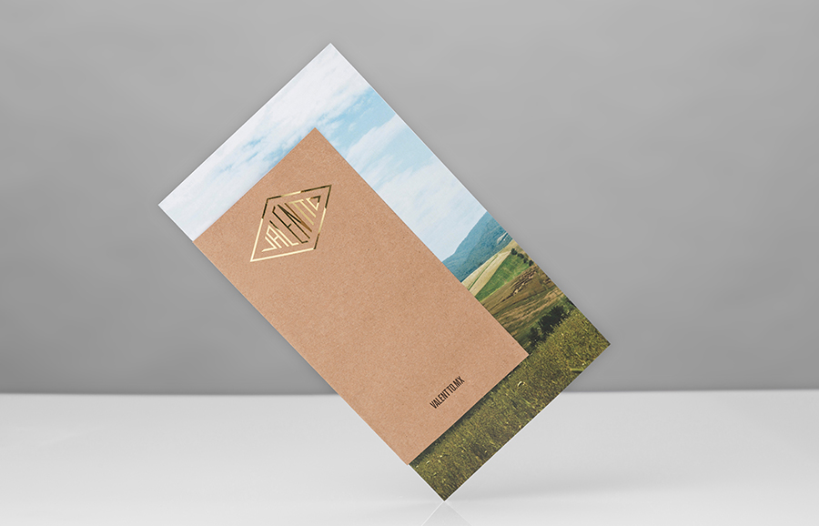 Logo and pamphlet with gold foil, photographic landscape and unbleached material detail designed by Anagrama for olive oil brand Valentto