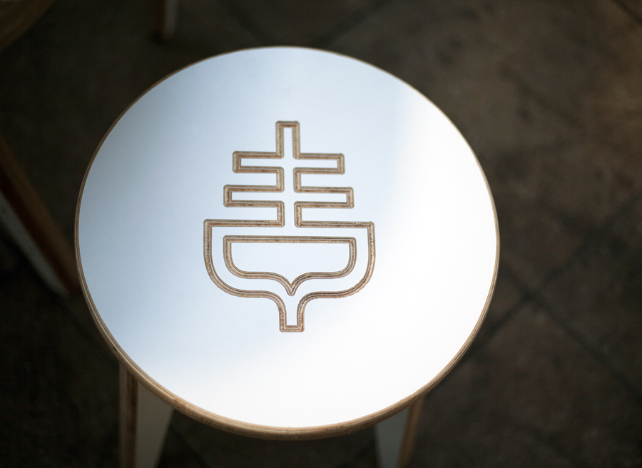 Table with logo cut detail designed by Graphical House for The Empire Café