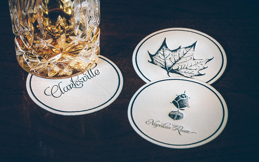 Coasters with stippled botanical illustration by FÖDA Studio for Clarksville fine dining restaurant Jeffrey's.