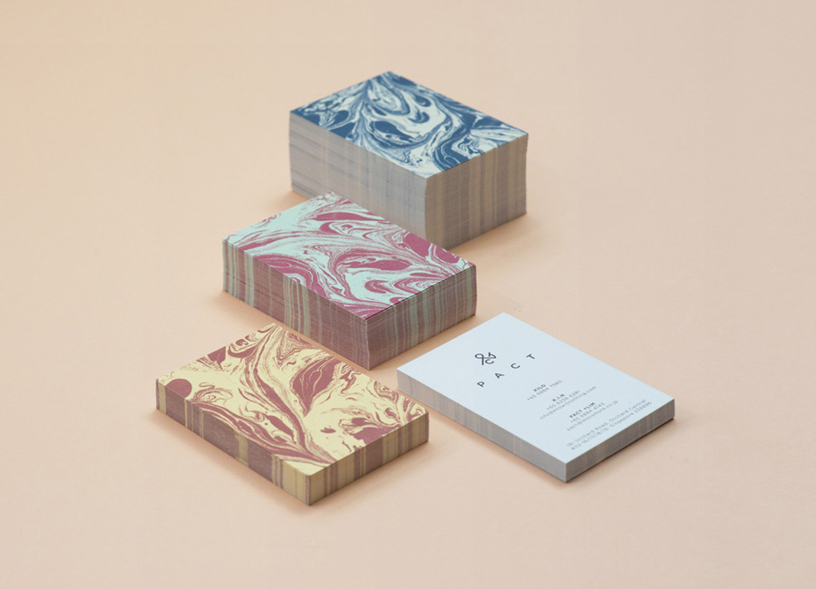 Logo and business card with marble pattern designed by Acre for co-branded retail partnership Pact