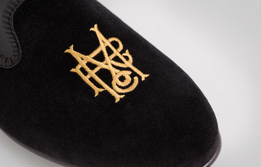 Serif monogram as a gold stitched detail designed by Anagrama for luxury slipper brand Romero+McPaul