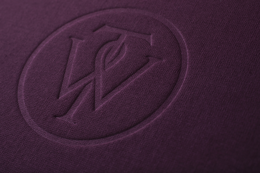 Notebook with purple textile and embossed monogram cover designed by Bunch for business consultancy Willow Tree 