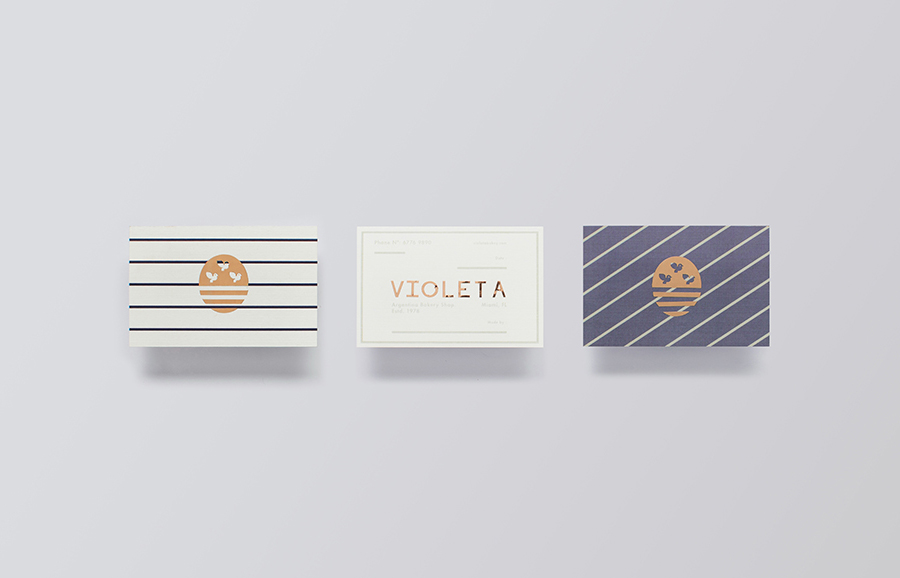 Logotype and business cards with copper foil detail designed by Anagrama for traditional Argentinian bakery Violeta