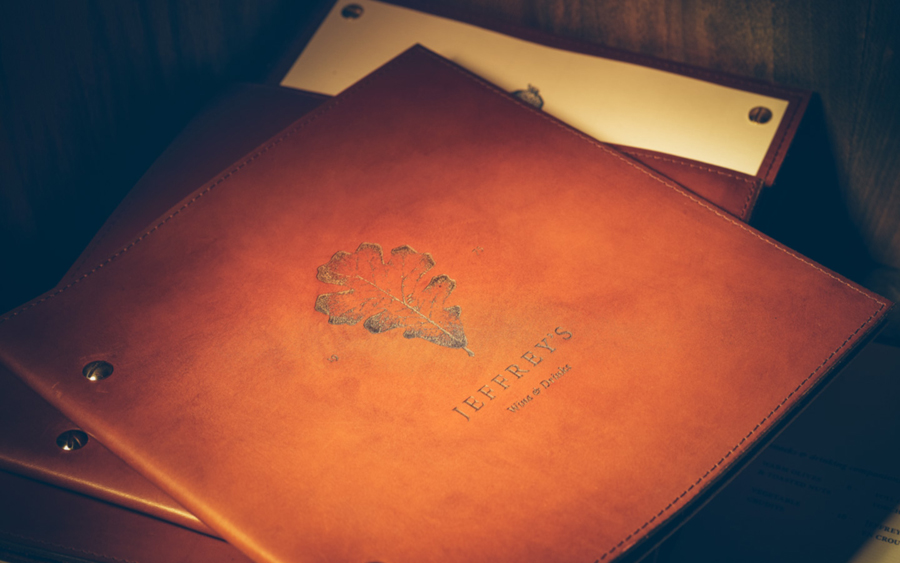 Leather bound menu with stippled botanical illustration by FÖDA Studio for Jeffrey's