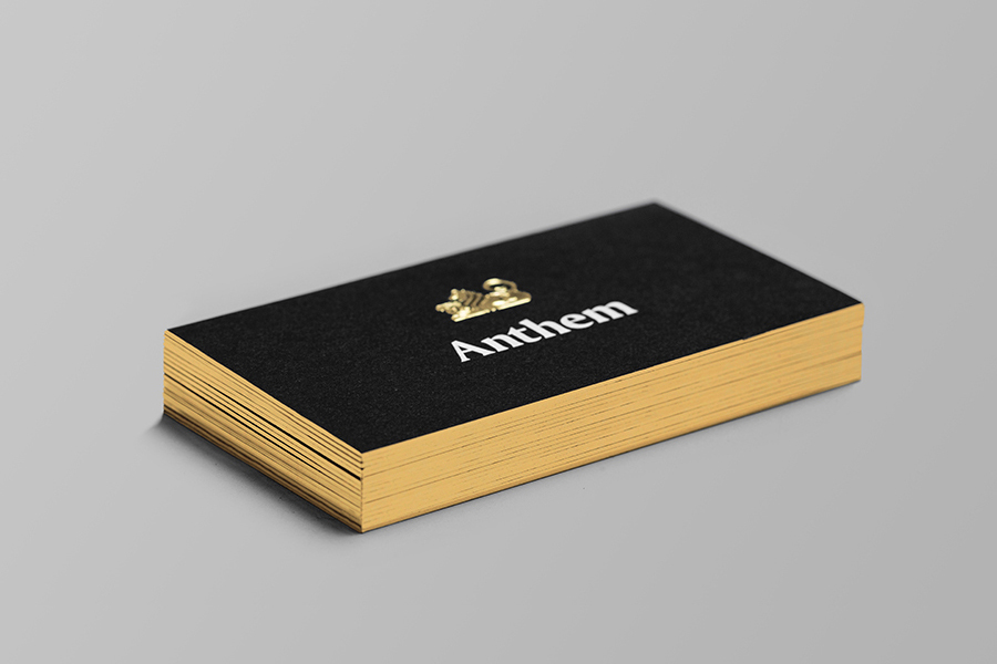 Logo and business card with embossed gold foil detail by Anagrama for football scout and transfer business Anthem