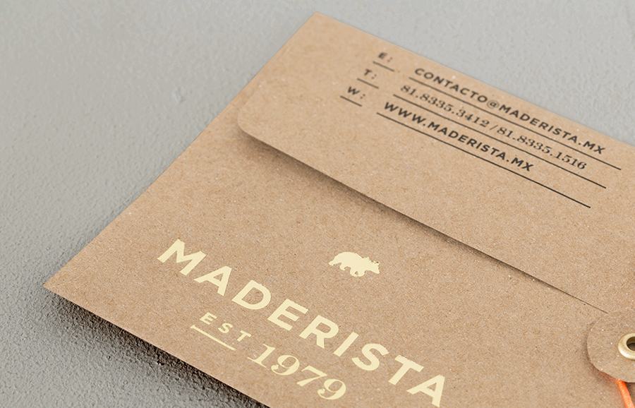 Logo and envelope with gold foil finish across an unbleached substrate designed by Anagrama for San Pedro-based carpentry studio Maderista