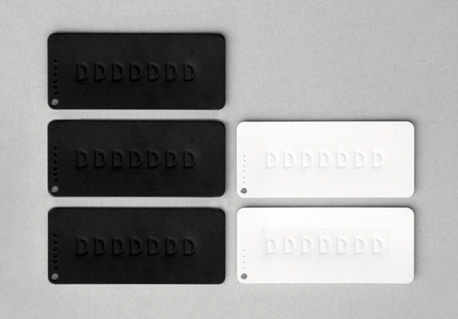 Blind embossed tags created by Demian Conrad Design for Swiss contemporary furniture design and manufacturer Dadadum