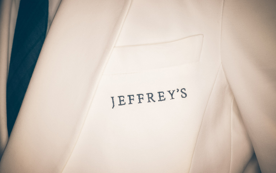 Logotype as a stitched uniform detail by FÖDA Studio for Jeffrey's