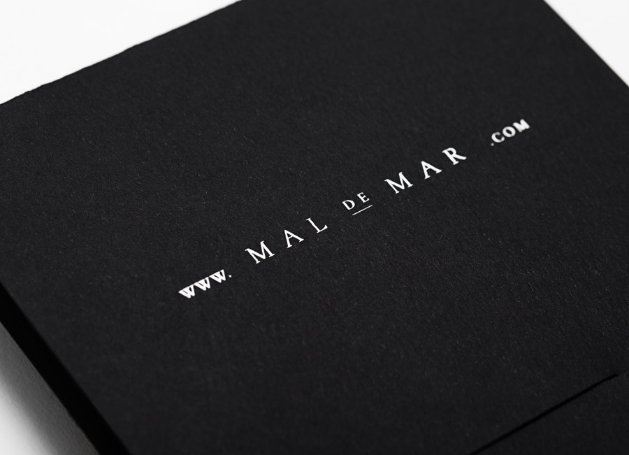 Logo and white foil folder for on-line art, design, architecture and photography journal Mal de Mar designed by Face