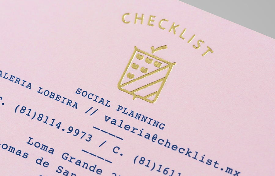 Logo as a gold block foil detail across a pink pastel paper designed by Anagrama for event panner Checklist