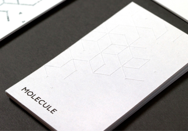 Logo and hand embossed business card for architecture and interior design studio Molecule created by Studio Round