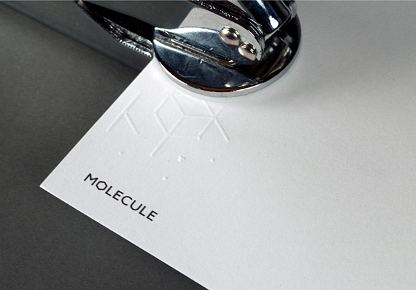 Logo and hand embossed business card for architecture and interior design studio Molecule created by Studio Round