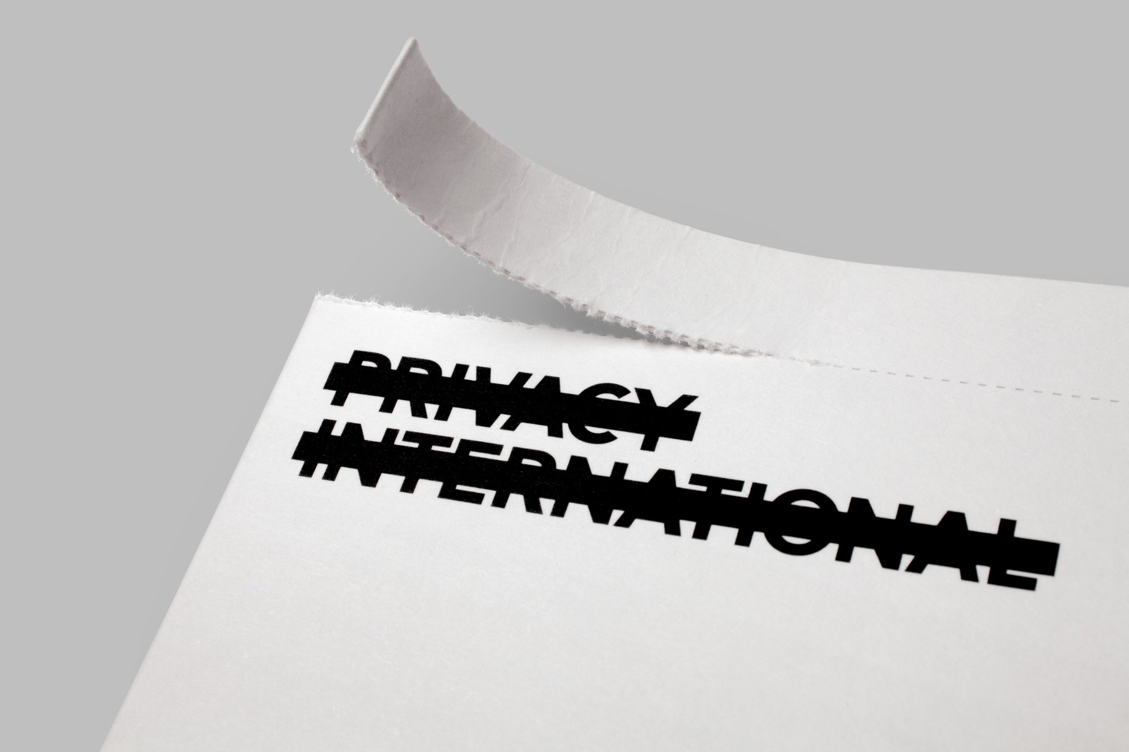 Logo and print with perforated detail designed by This Is Real Art for Privacy International