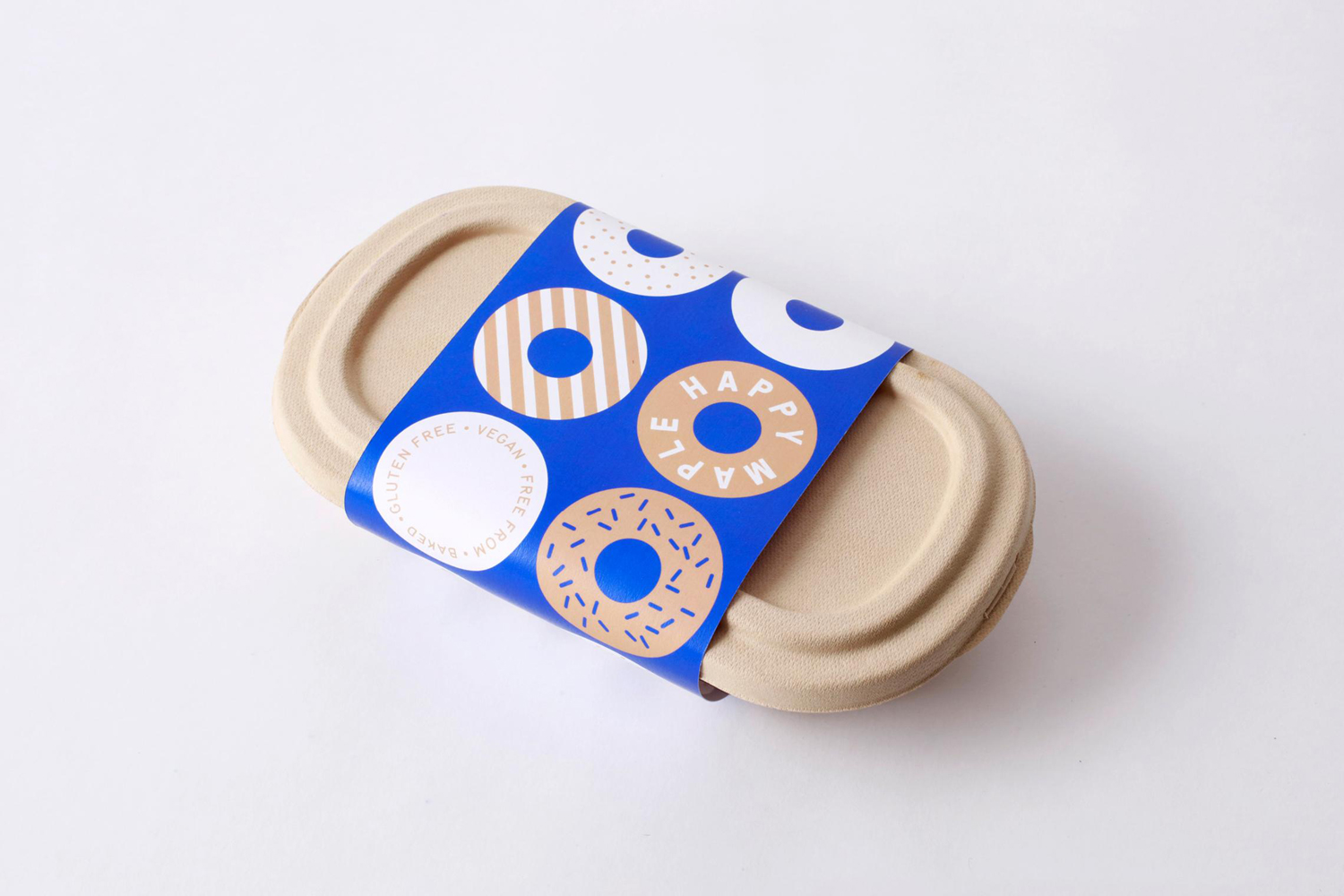 Brand identity and packaging by Sydney-based graphic design studio Garbett for donut bakery Happy Maple. 