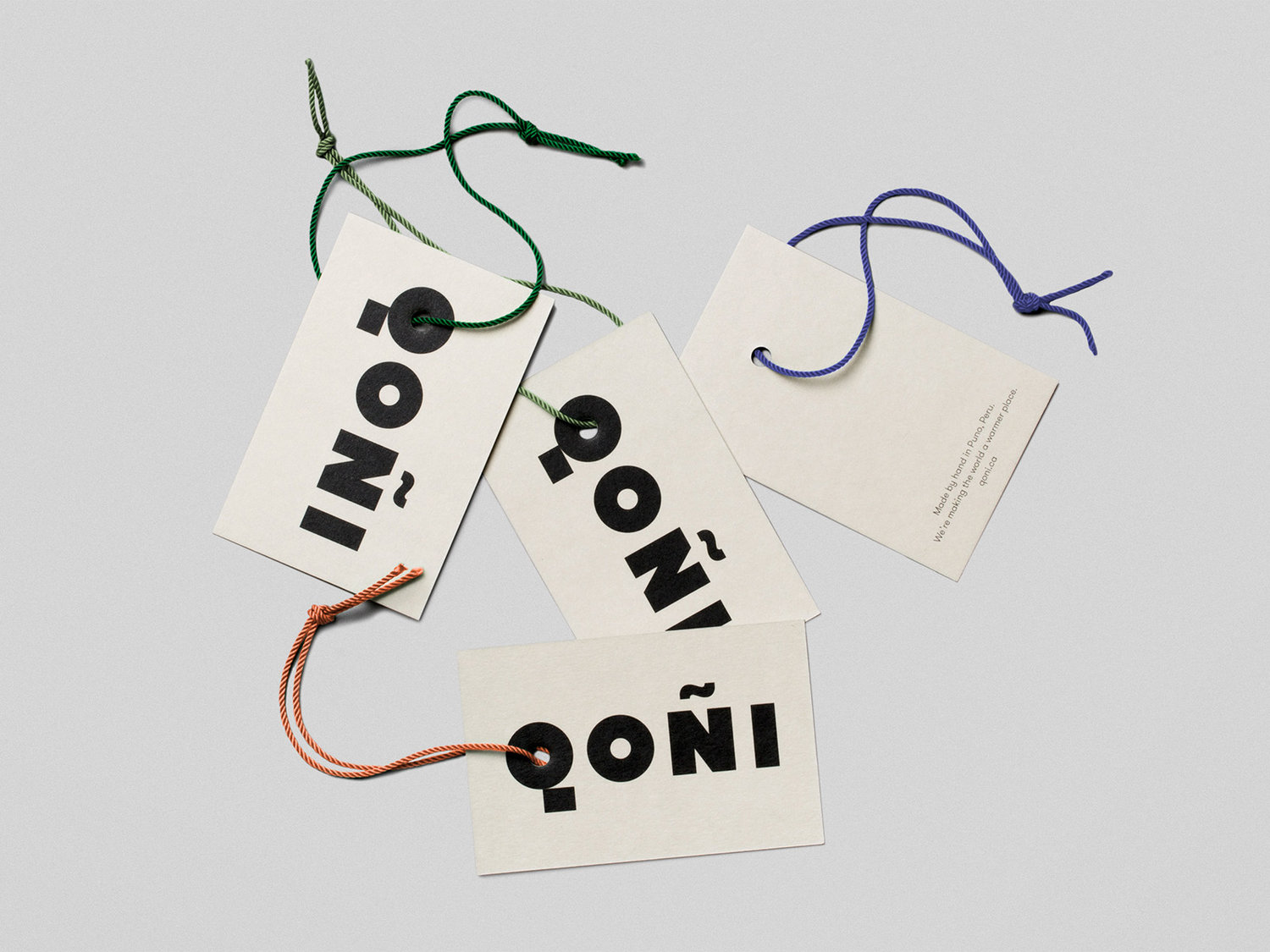 Logotype and uncoated and unbleached products tags by Toronto-based Leo Burnett Design for Peruvian handmade knitwear brand Qoñi