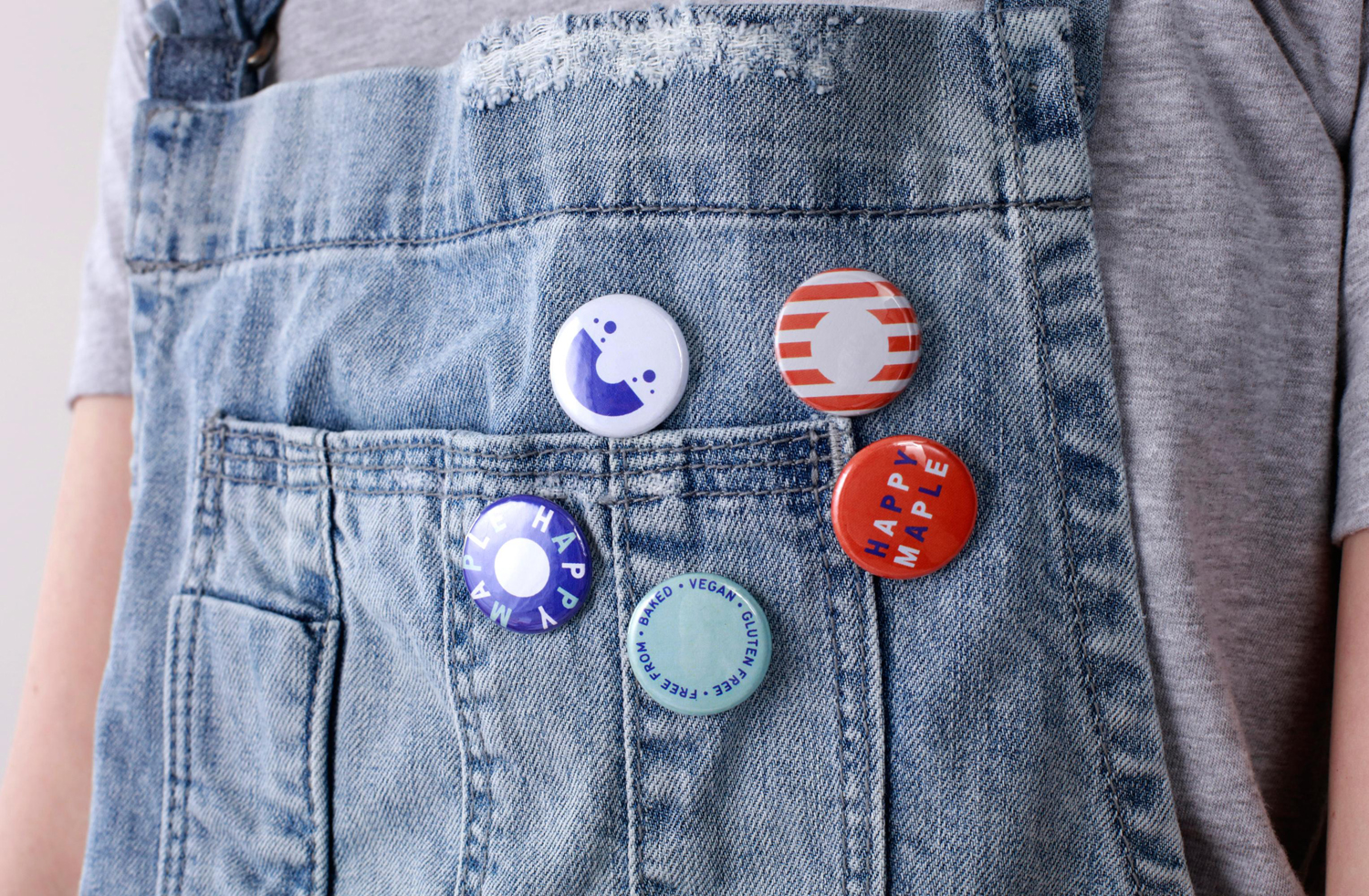 Brand identity and badges by Sydney-based graphic design studio Garbett for donut bakery Happy Maple. 