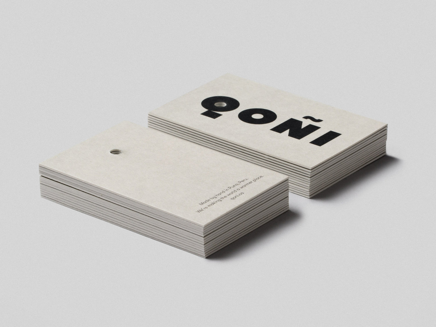 Logotype and uncoated and unbleached products tags by Toronto-based Leo Burnett Design for Peruvian handmade knitwear brand Qoñi