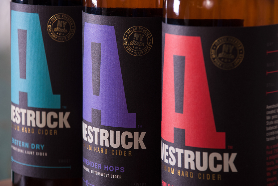 Logo and packaging treatment with laid paper and copper foil detail designed by Buddy for Awestruck Hard Cider