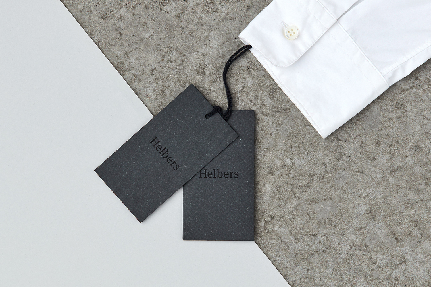 Logotype and black block foiled tags by Leeds-based graphic design studio Only for Parisian menswear label Helbers