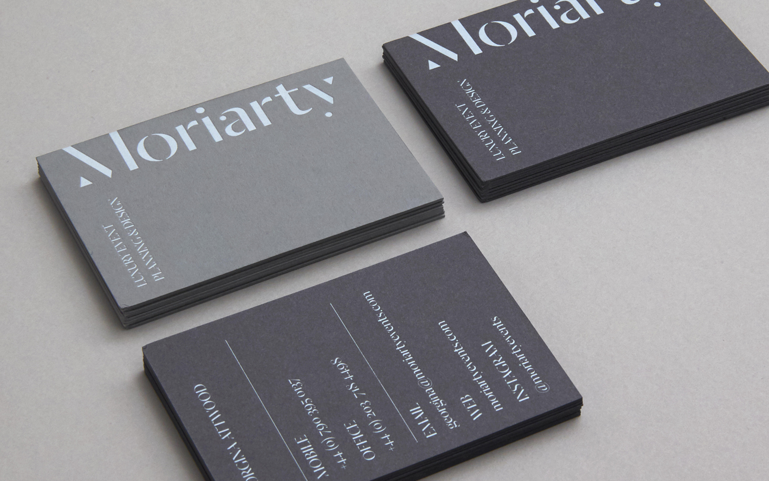 Visual identity and grey business cards with a white block foil detail designed by Bond for London-based event planning business Moriarty