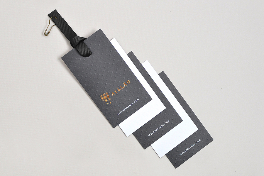 Tags with copper foil and blind emboss detail for Latin American fashion brand champion Atelán by Firmalt