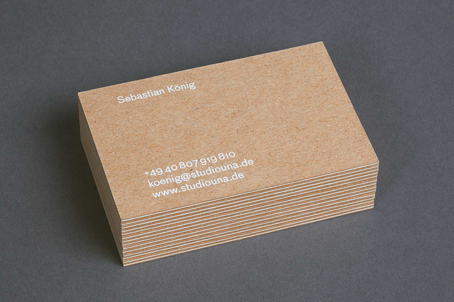 Kraft paper business cards with white ink print finish by German graphic design business Studio Una