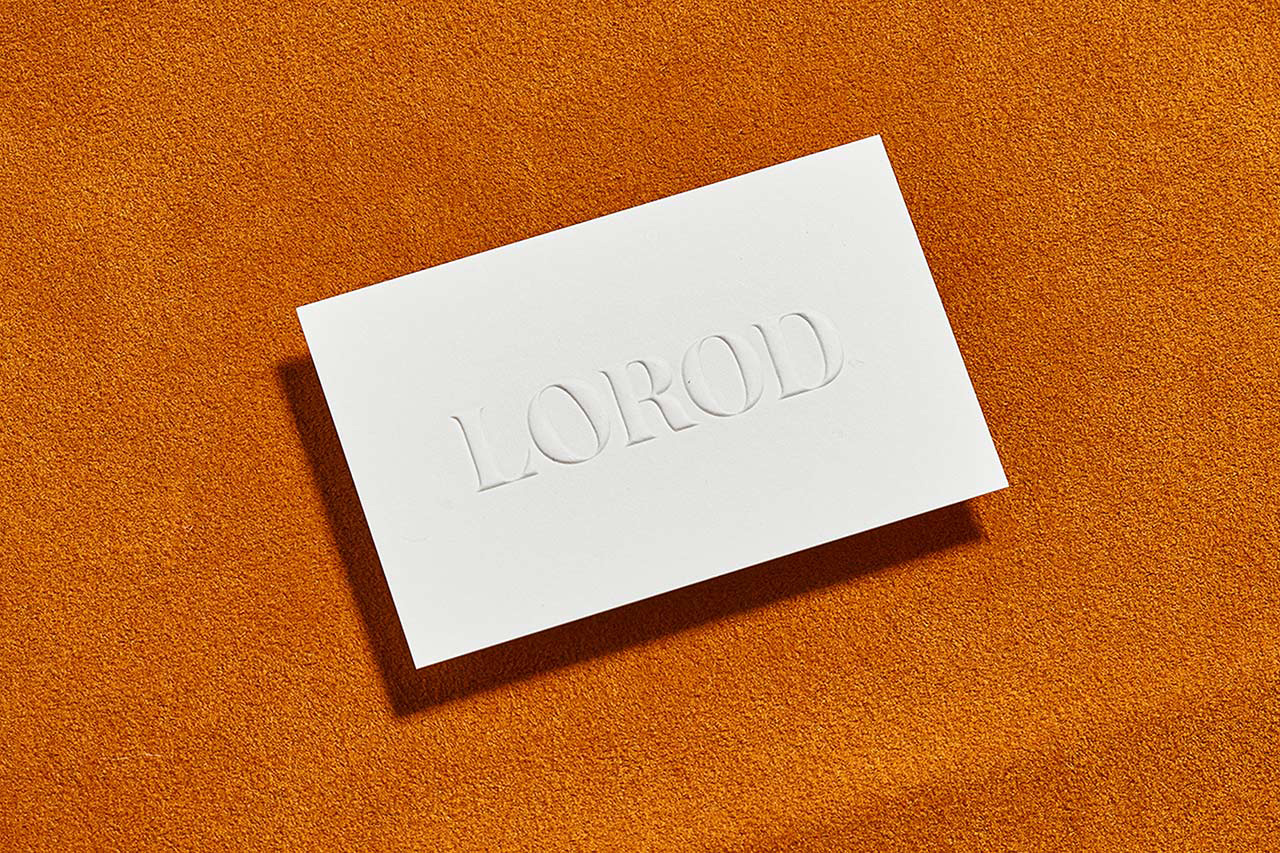 Brand identity and blind embossed business card by Pentagram for fashion brand Lorod. 