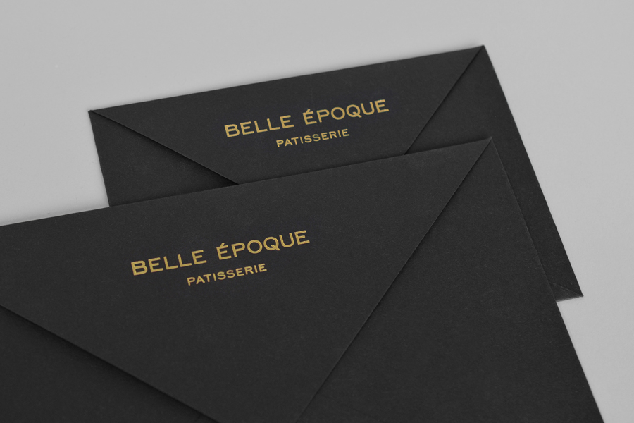 Black envelopes with gold block foil detail for London based French Patisserie Belle Epoque by Mind Design