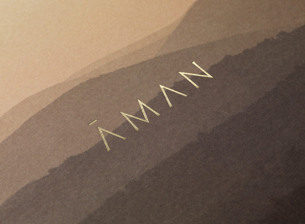 Brand identity and gold foiled brochure cover for luxury resort business Aman by Construct, United Kingdom