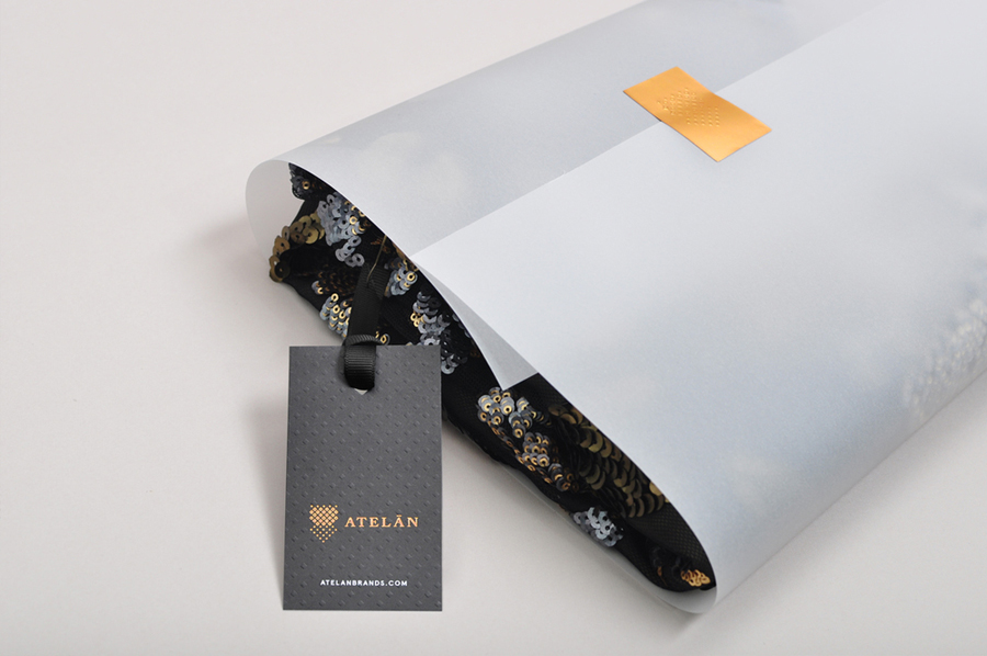 Tags with copper foil and blind emboss detail for Latin American fashion brand champion Atelán by Firmalt