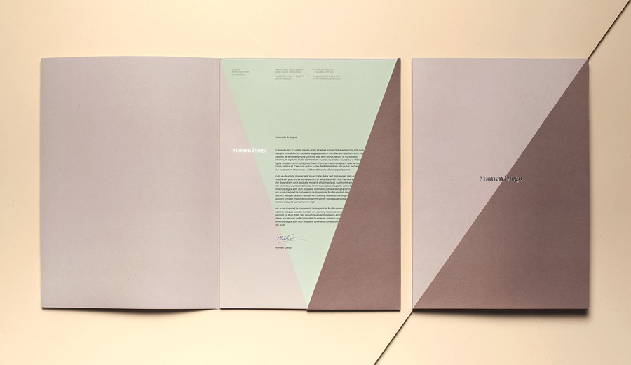 Visual identity, folder and headed paper by graphic design studio Atipo for Spanish architecture and interior design firm Mamen Diego. 