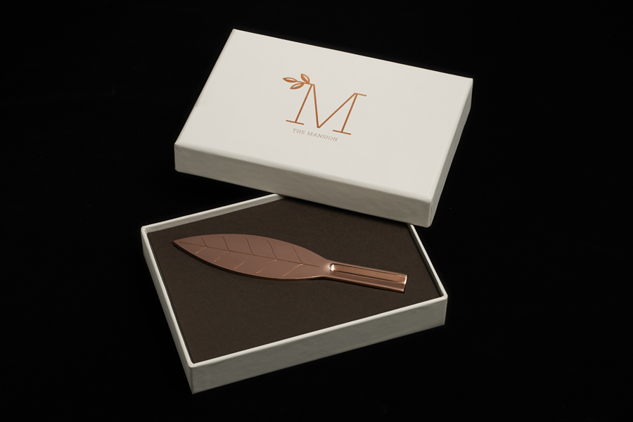 Copper block foiled box and letter opener by Pentagram for new property development The Mansion on Marylebone Lane