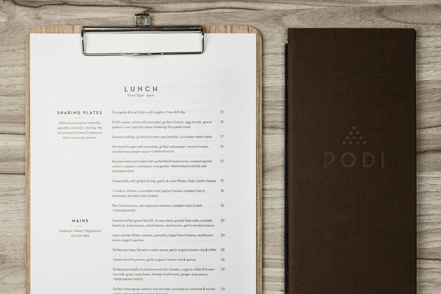 Logotype and menu with wood and fabric detail designed by Bravo Company for Singapore-based organic restaurant Podi