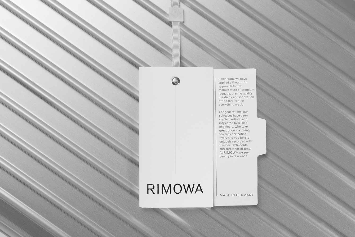 Graphic identity and tag designed by Commission studio for functional luxury luggage manufacturer Rimowa