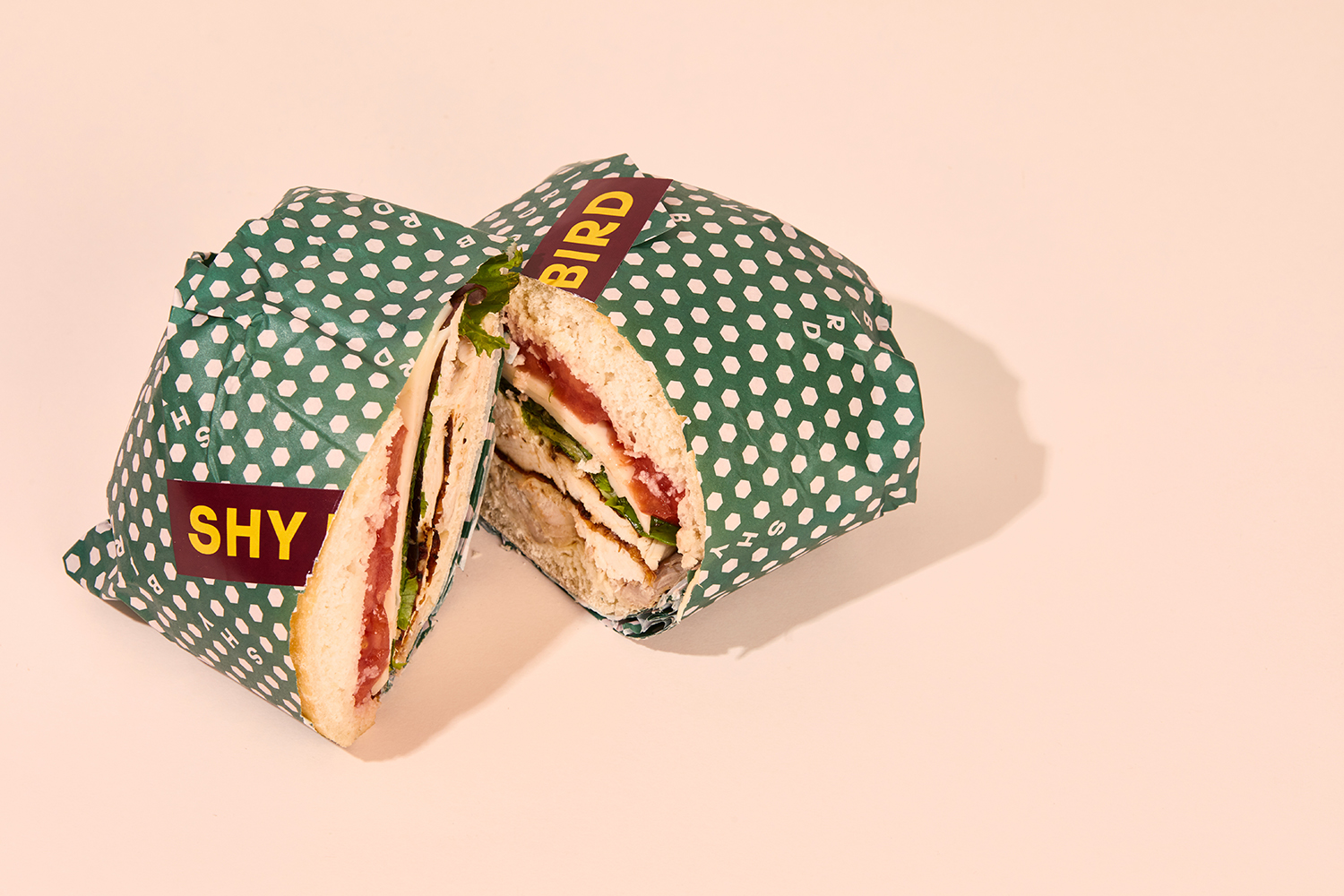 Logotype, pattern and sandwich wrap by Perky Bros for Shy Bird, a café, rotisserie and bar in Cambridge, MA