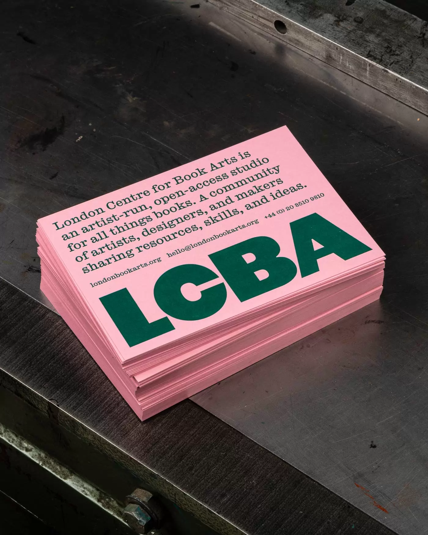 Pink and green typographic postcard design for the Lo<em></em>ndon Centre for Book Arts designed by Studio Bergini