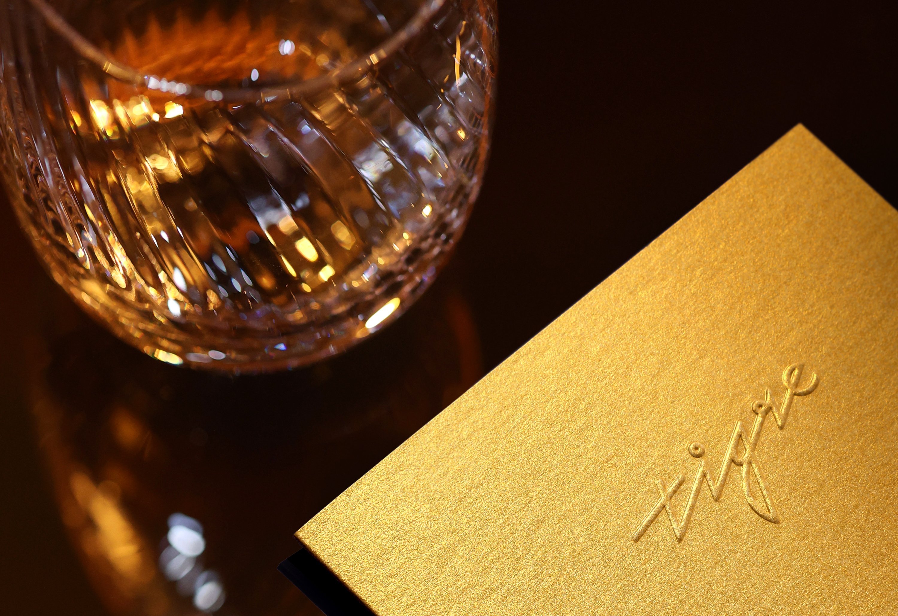 Cursive logotype, menu design, coaster and matchbooks for New York bar Tigre designed by Triboro. 