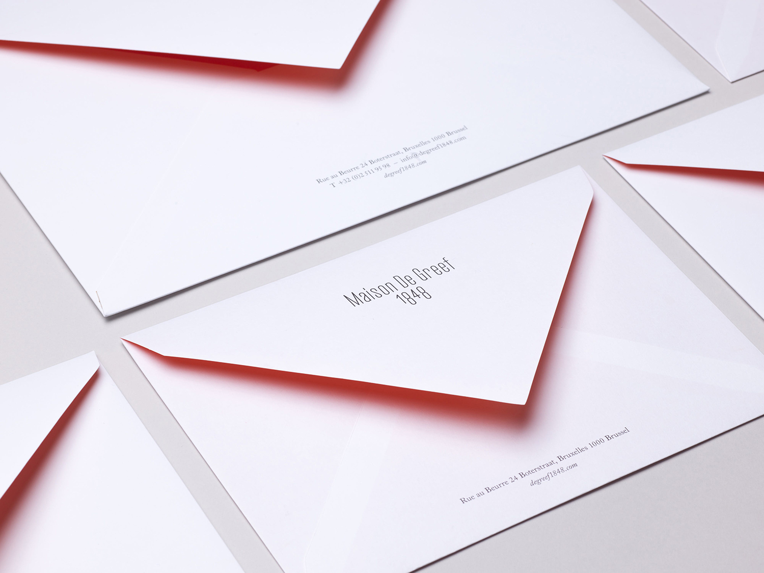 Envelope design with spot colour interior by Base Design for high-end jewellery brand, expert watchmaker and retailer Maison De Greef 1848