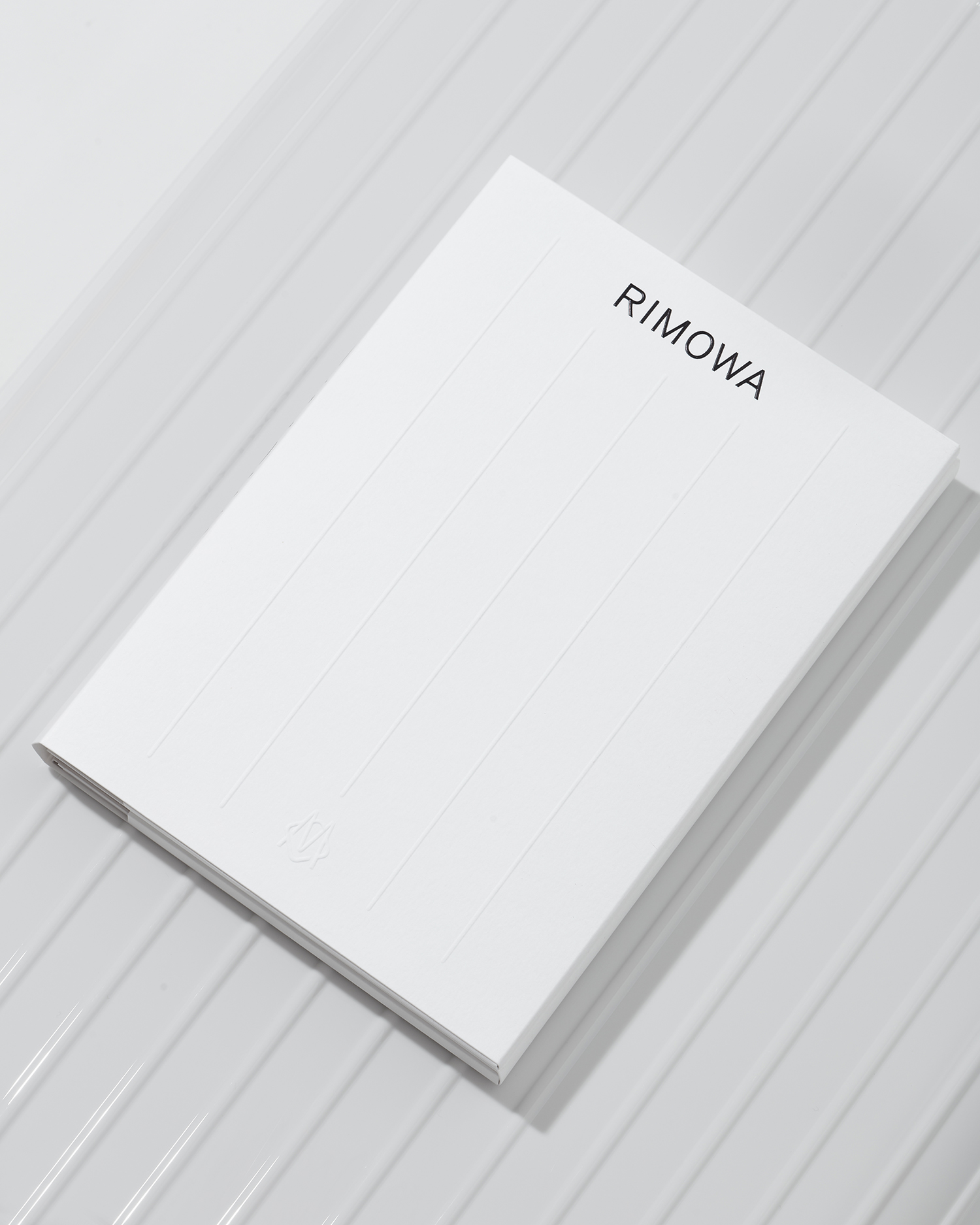 Graphic identity and embossed folder by Commission studio for functional luxury luggage manufacturer Rimowa
