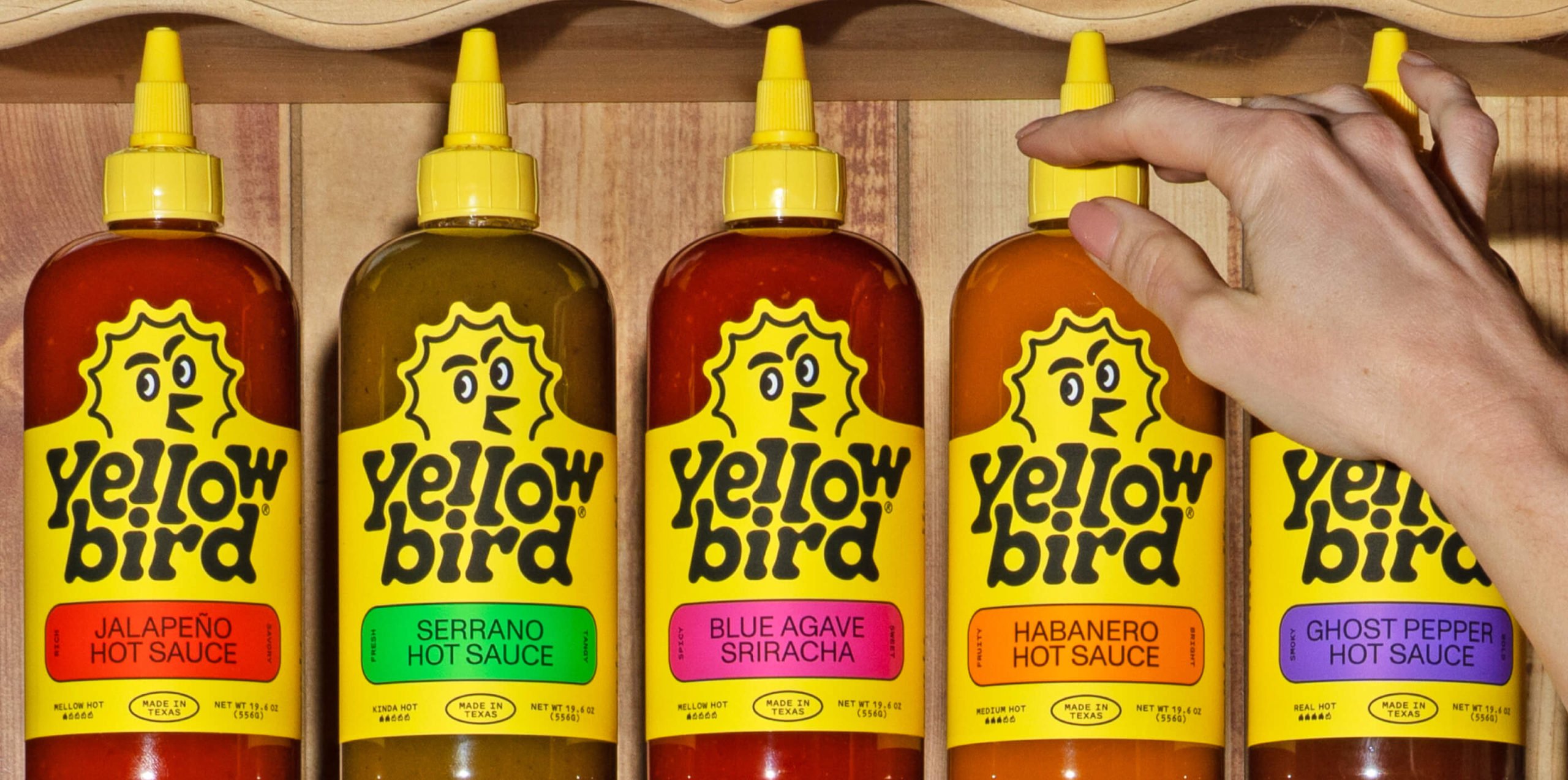 ogotype, packaging, illustration, website and social media assets for American hot sauce brand Yellowbird designed by Brooklyn-based studio Gander.