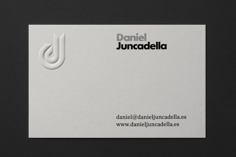 White blind embossed business card design with silver ink detail by Mucho for racing driver Daniel Juncadella