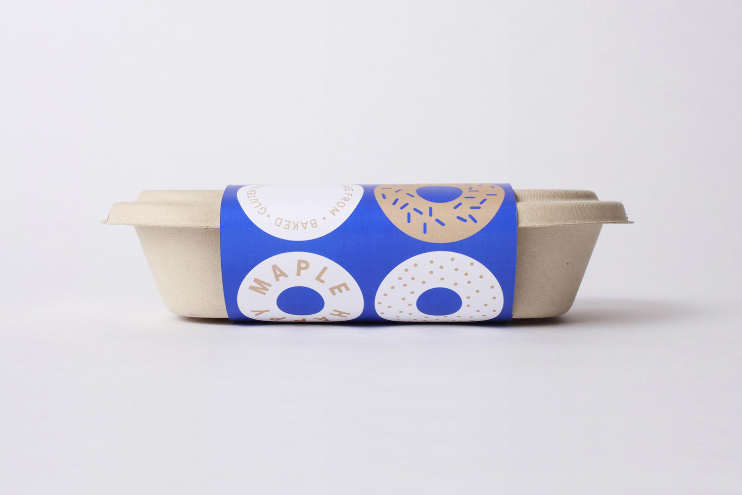 Brand identity and packaging by Sydney-based graphic design studio Garbett for donut bakery Happy Maple. 